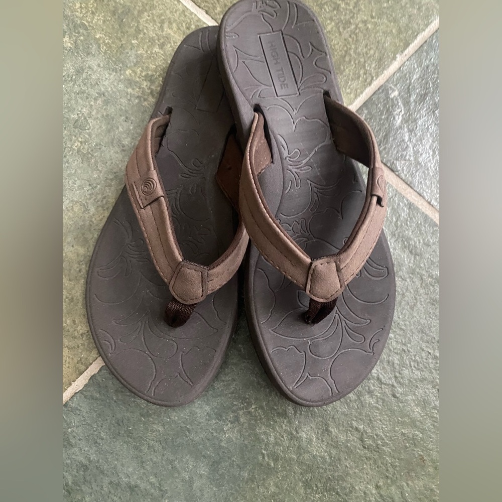 Brown leather flip flops.